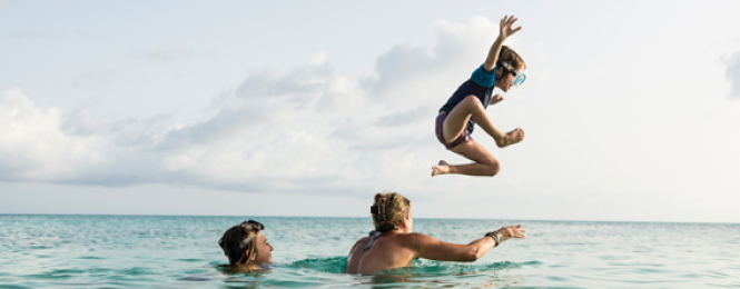 Family swimming in the ocean